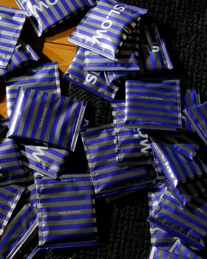 SL.OW steeped coffee bags scattered on a table
